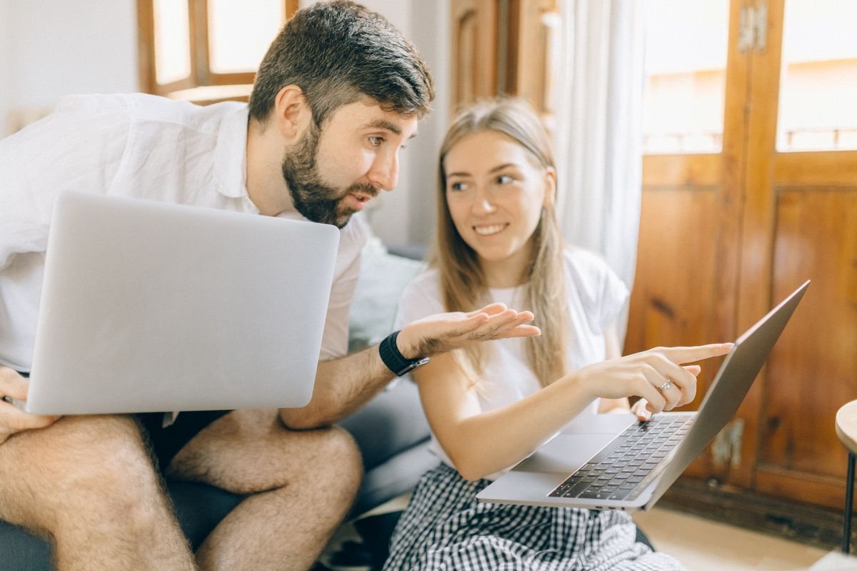 Two people looking at a laptop together