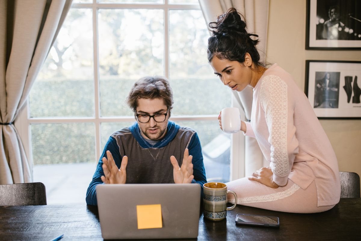 A pair working through notes at a laptop